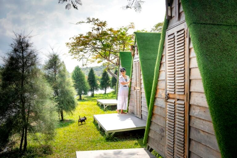 Woman standing on porch of bungalow in camping